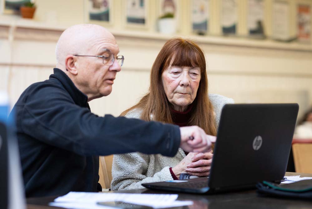 Older people accessing vcc platform on laptop.